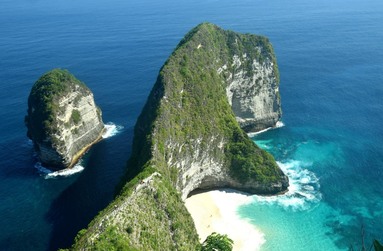 A breathtaking aerial shot of Kelingking Beach cliffs in blue ocean waters, Nusa Penida.